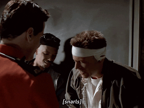 a man with a bandage on his head is talking to another man with a bandage on his head