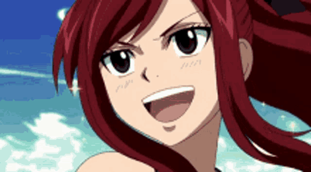a girl with red hair is smiling with a blue sky behind her