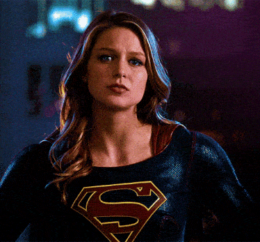 a woman is wearing a superman costume with a red s on it