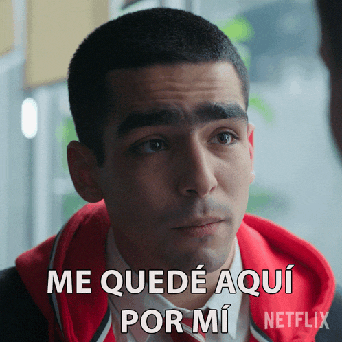 a man in a red jacket says " me quede aqui por mi " in spanish