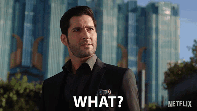 a man in a suit says what in front of a netflix building