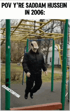 a man is hanging from a rope in a park with the caption pov y 're saddam hussein in 2006