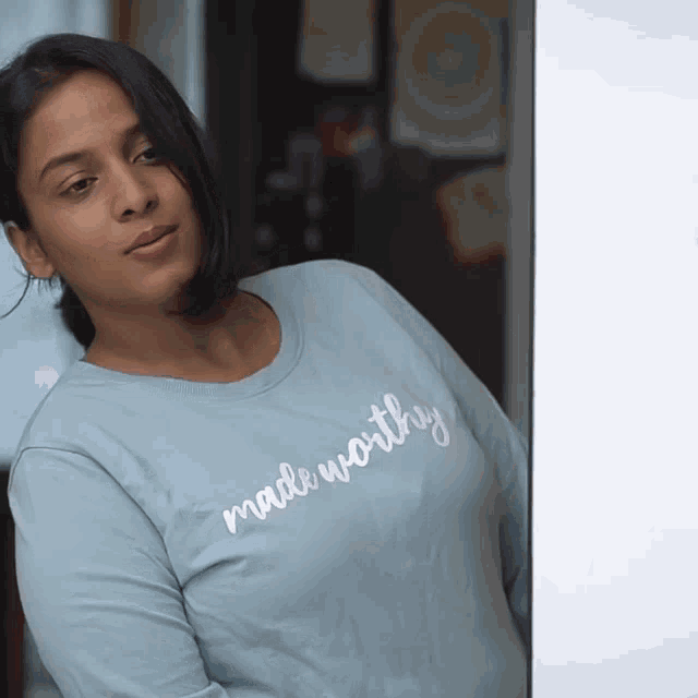 a woman wearing a shirt that says " made worthy "