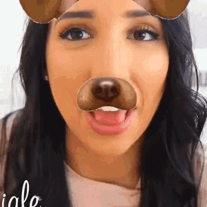 a woman wearing a snapchat filter with a dog nose on her face .