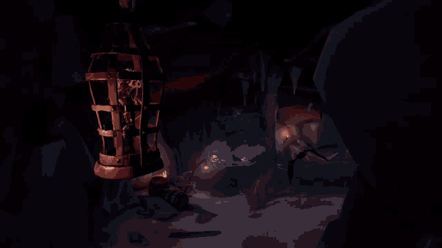 a cave with a cage hanging from the ceiling and a few bats flying around