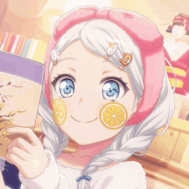 a girl with lemon slices on her face is smiling and holding a book