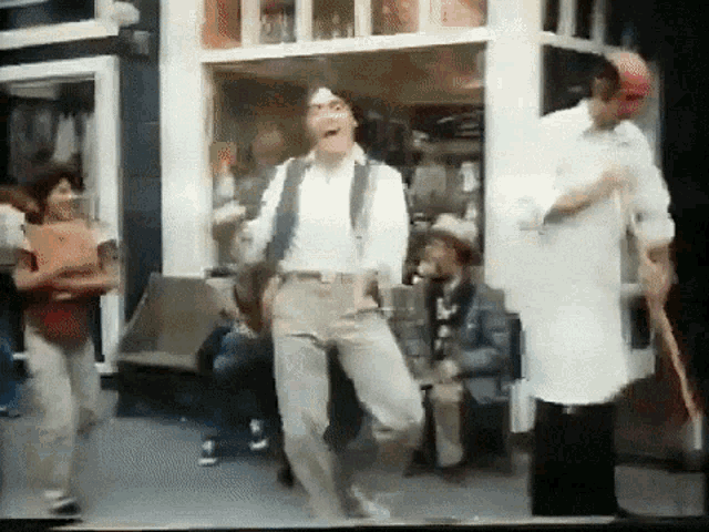 a group of people are dancing outside of a store