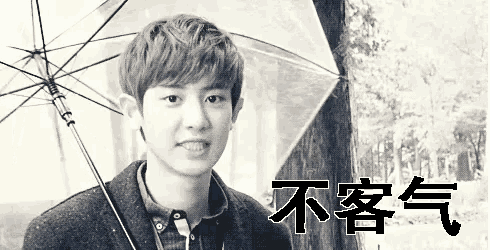 a black and white photo of a young man holding an umbrella with chinese writing on it