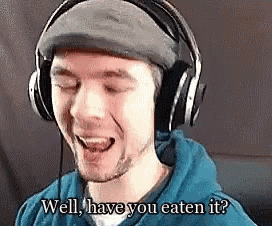 a man wearing headphones and a hat is laughing and asking if he has eaten it .