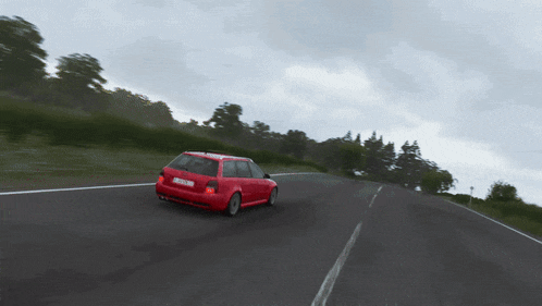 a red car is driving down a road with a license plate that says ' nz ' on it