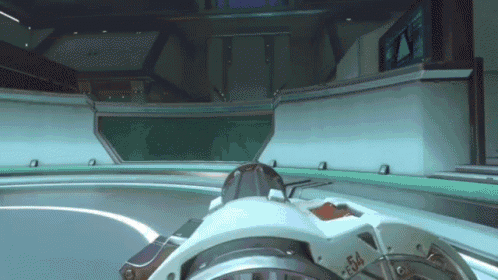 a video game is being played in a room with a steering wheel that says f4 on it .