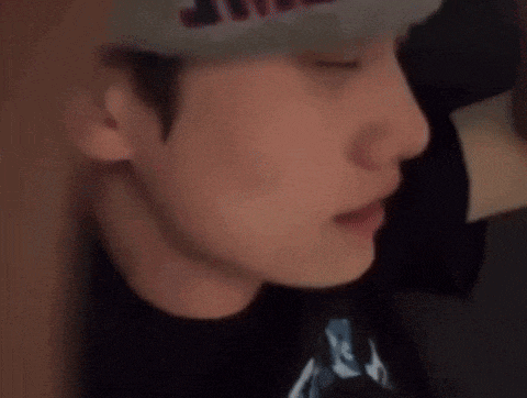a close up of a man 's face wearing a hat .