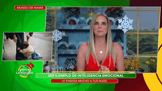 a woman in a red dress stands in front of a green screen that says mundo de mama on it