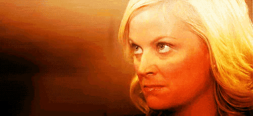 a close up of a woman 's face with blonde hair and blue eyes .