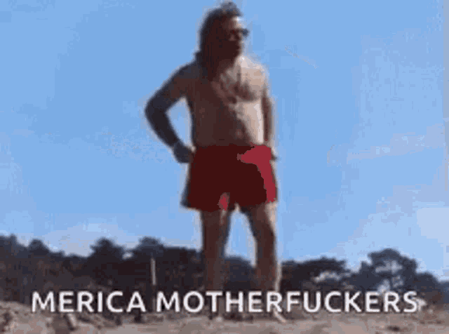 a shirtless man in a bikini is standing in front of two airplanes flying in the sky .
