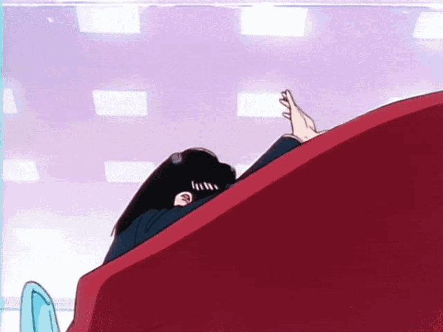 a cartoon character is laying on a red couch