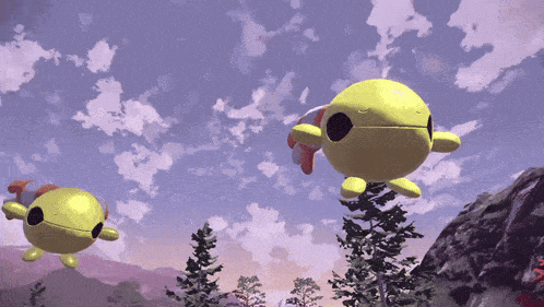 two yellow balls are flying in the sky over a forest