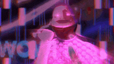 a man in a pink shirt is standing in front of a neon sign that says ' wow ' .