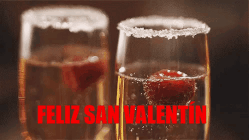 two glasses of champagne with the words feliz san valentin in red letters