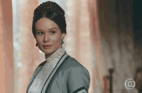 a woman with a braided hair and a gray jacket