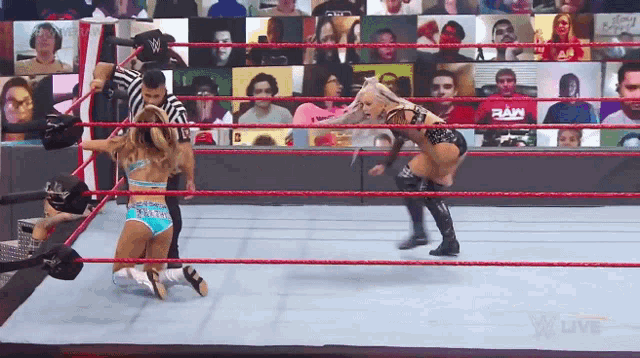 two women are wrestling in a ring with a referee and a ram logo in the background
