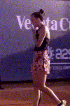 a woman walking in front of a banner that says venta