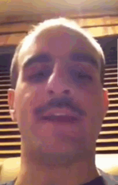 a close up of a man 's face with his eyes closed