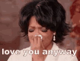 oprah winfrey is crying while holding a napkin to her nose .