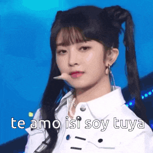 a girl with pigtails and a microphone in her mouth .