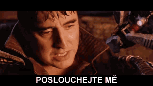 a close up of a man 's face with the words poslouchejte me below him