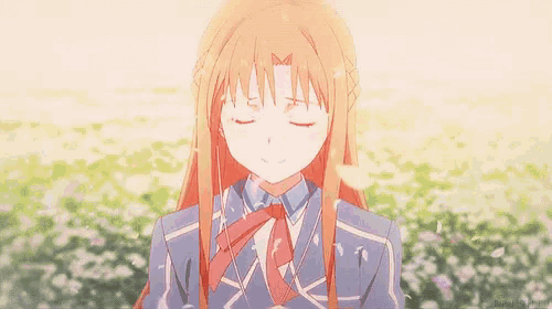 a close up of a girl with her eyes closed in a field of flowers