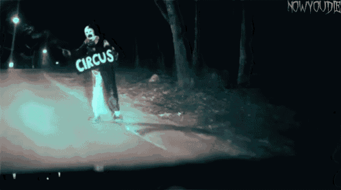 a clown is holding a sign that says circus on it