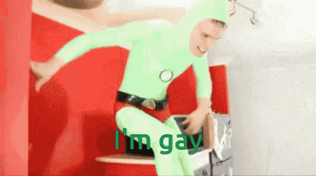 a man in a green suit says i 'm gay in green letters