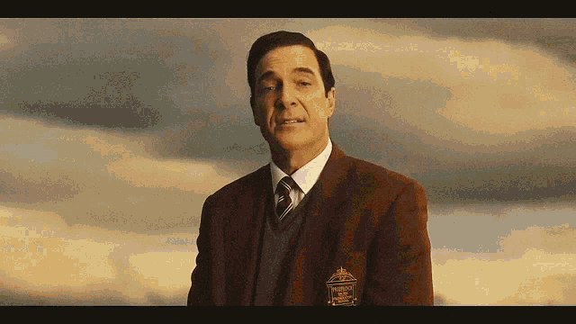 a man in a suit and tie has a patch on his chest that says president 's club