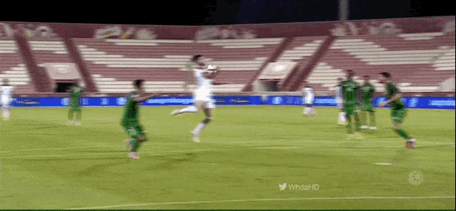 a soccer game is being played in an empty stadium sponsored by whoahd