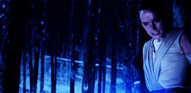 a woman in a sling is standing in a dark room