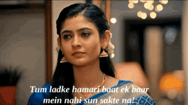 a woman in a blue saree with the words tum ladke hamari baat ek baar mein nahi sun sakte na