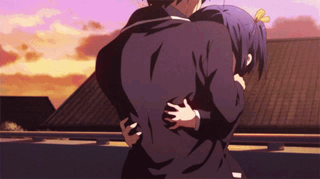 a man and a girl are hugging each other in front of a roof