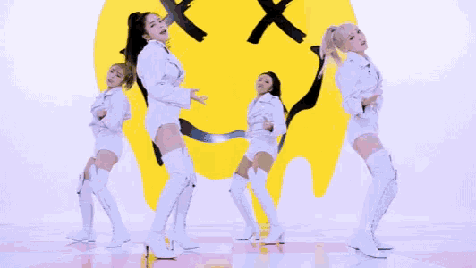 a group of women are dancing in front of a smiley face