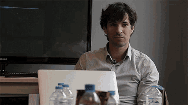 a man sitting in front of a samsung computer