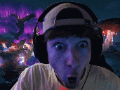 a man wearing headphones and a baseball cap looks surprised