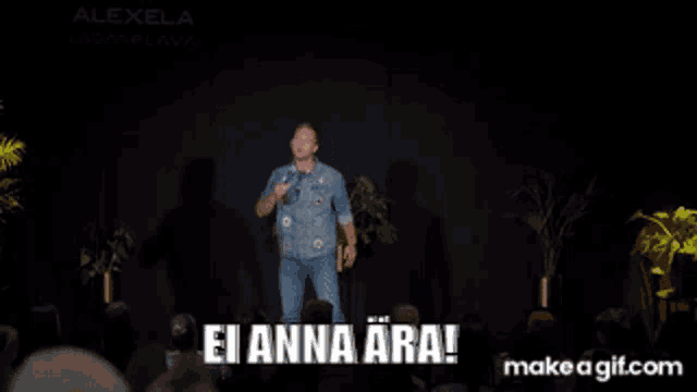a man stands on a stage with the words ei anna ara written on it