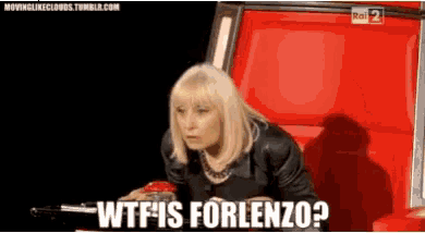 a woman is sitting in a red chair and saying wtf is forlenzo