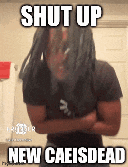 a man with dreadlocks is standing in front of a mirror with the words shut up new caeisdead written above him