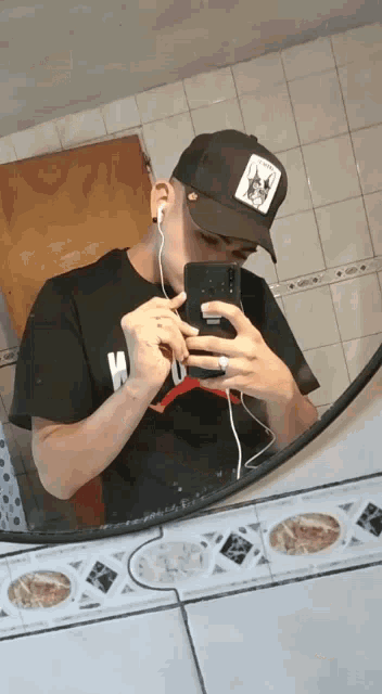 a man is taking a picture of himself in a bathroom mirror