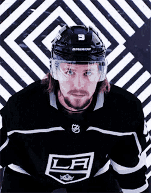 a hockey player wearing a la jersey and helmet