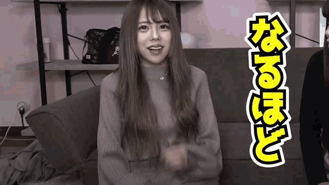 a woman is sitting on a couch with a yellow sticker that says ' n'e ' on it