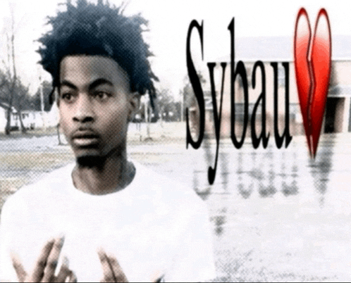 a young man stands in front of a broken heart and sybau