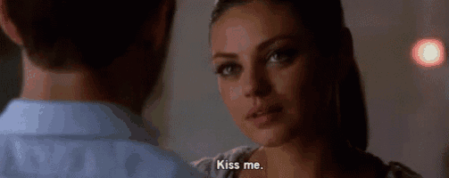 a man and a woman are kissing and the woman is saying kiss me .