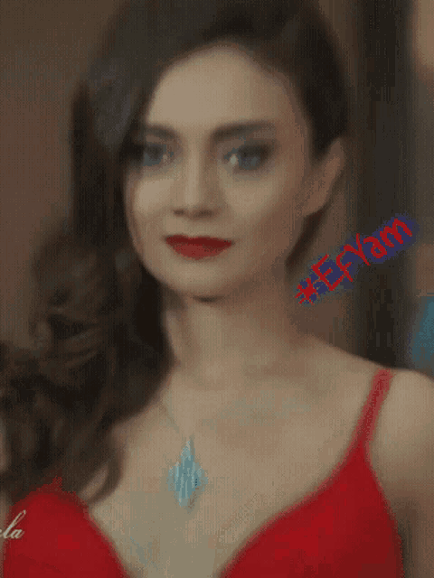 a woman wearing a red bra and necklace has the name eeyahn on the bottom